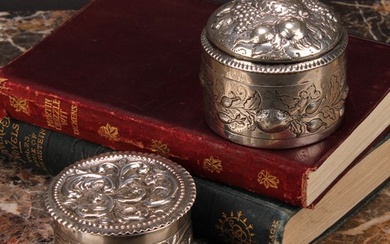 A Victorian silver circular box and cover, chased with scrol...