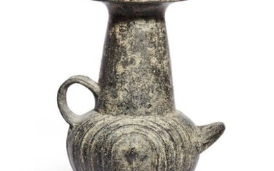 A Villanovan impasto ware urn, 8th Century B.C., the bulbous body decorated on each side with a central conical protrusion, surrounded by raised concentric ring motifs, surmounted by a slightly tapering columnar neck, with a flat circular rim...
