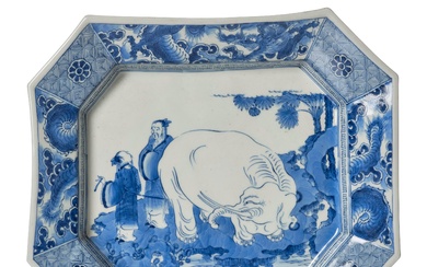 A blue and white dish with an...