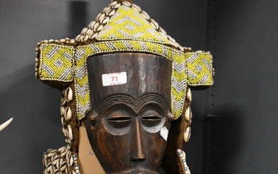 A central African carved wood, bead, shell and grass ornamented Lele (Democratic Republic of