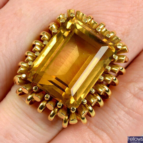 A citrine dress ring, with cylindrical and spiral surrounds.
