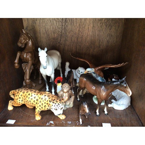 A collection of assorted ceramic animal figures, predominant...