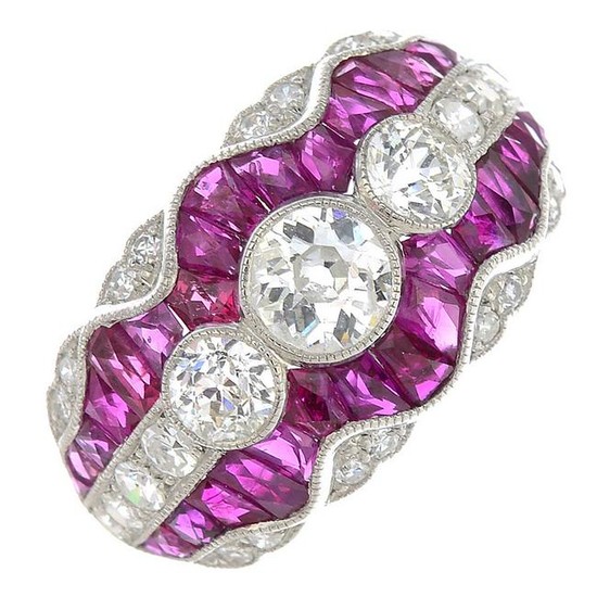 A diamond and ruby dress ring.Estimated total diamond