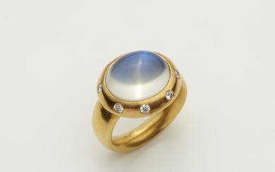 A hand forged 18k gold and diamond ring with large moonstone cabochon.