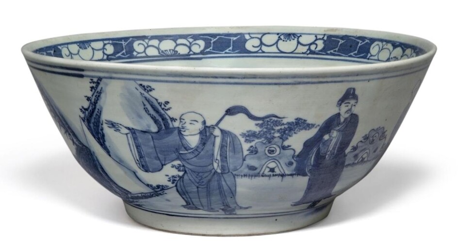 A large Chinese porcelain blue and white bowl, 19th century, decorated with scholars and attendants in a continuous landscape, apocryphal underglaze blue Qianlong four-character mark to base, 29cm diameter