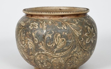 A large Martin Brothers stoneware jardiniere, ovoid with collar rim, incised with scrolling flowers and foliage in shades of brown and white on a buff ground, incised 1-1889 Martin Bros London & Southall, body star-crack and hairline, 26cm. high