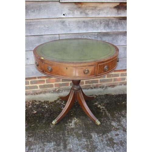 A mahogany drum table with tooled lined gilt green leather t...