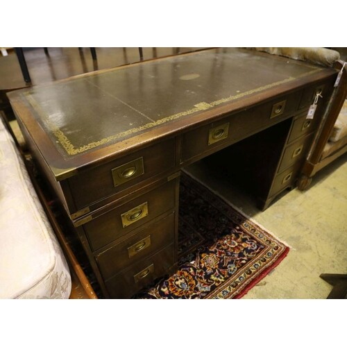 A military style mahogany and brass bound twin pedestal desk...