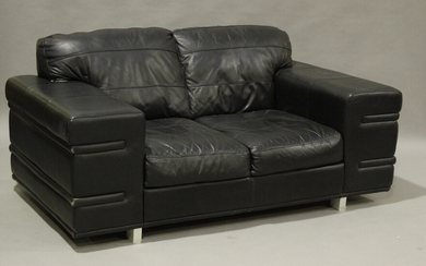 A modern black leather designer sofa, raised on block legs, height 78cm, width 169cm, depth 94cm.