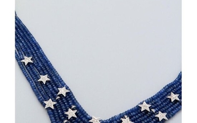 A necklace composed of 7 rows of sapphires set with alternating shiny rings and star motifs set with diamonds in white gold. The baguette motif of the white gold clasp set with diamonds.