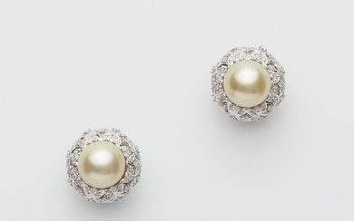 A pair of 14k white gold diamond and cultured pearl stud earrings.