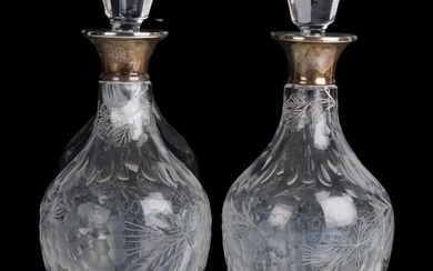 A pair of Elizabeth II silver-mounted glass wine decanters a...