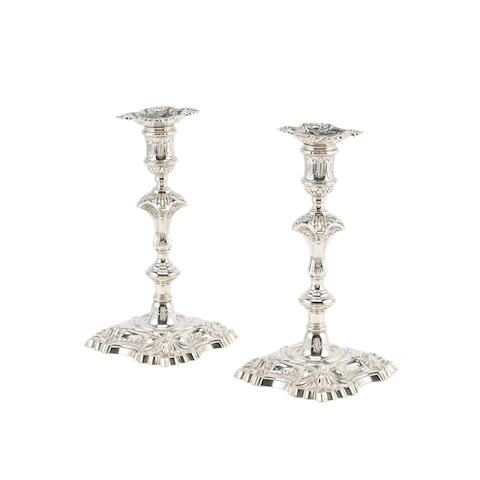 A pair of George II cast silver candlesticks mark of William Gough, London 1747 overstriking that of another (2)