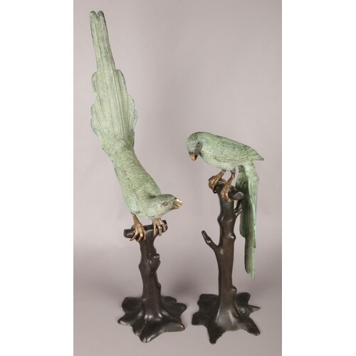 A pair of cold painted bronze parakeet statues on naturalist...