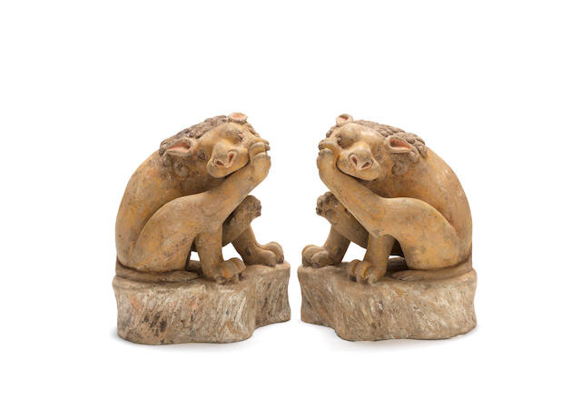 A pair of pottery models of lions