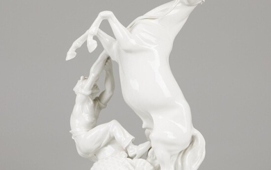 A porcelain equestrian group of a stallion and groom, Erich Oehme (1898-1970) in front of...