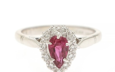 A ruby and diamond ring set with a pear shaped ruby encircled by numerous brilliant-cut diamonds, mounted in 18k white gold. Size 53.