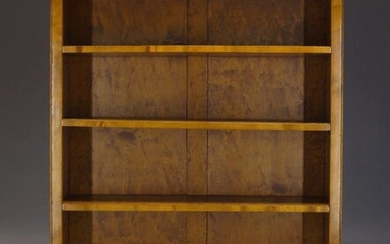 A satinwood freestanding open bookcase, mid 20th Century, with three...