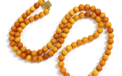 A single row uniform spherical butterscotch amber bead necklace