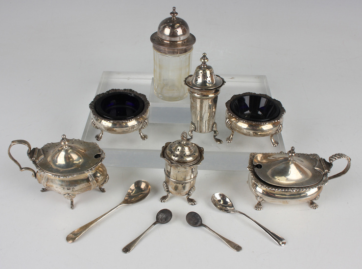 A small collection of silver condiments, including a pair of Victorian circular salts with blue glas