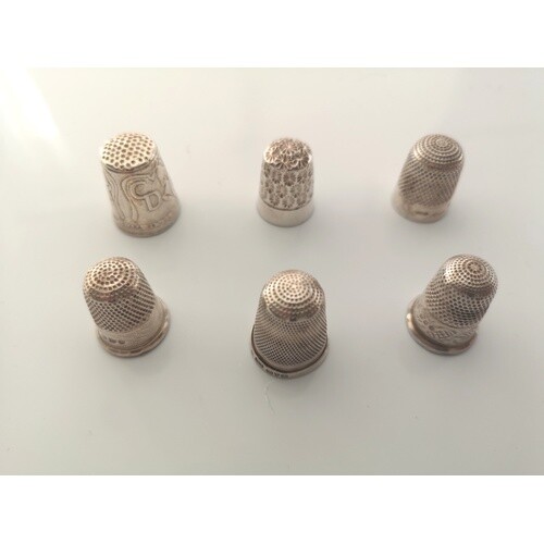 A small collection of sterling silver thimbles. Various date...