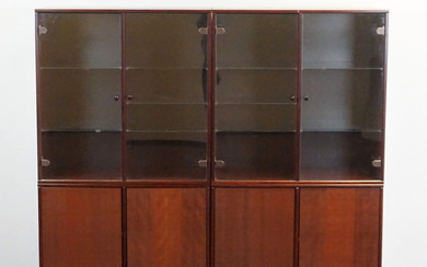A two piece mahogany veneer display cabinet with lighting.
