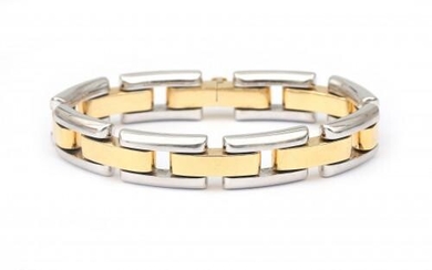 An 18 karat gold two tone link bracelet. Composed of puffy alternating links in white and yellow gold, to a tongue clasp. Gross weight: 39.36 g.