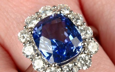 An 18ct gold sapphire and diamond cluster ring.Sapphire weight 5.72cts.Total diamond weight 1.64cts