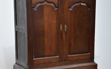 An 18th century oak cupboard chest, with two panelled doors...
