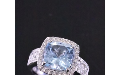 An Aquamarine and diamond cluster ring set in 18ct gold fing...