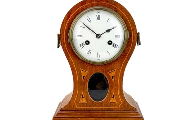 An Edwardian mahogany and inlaid balloon-shaped mantel clock.