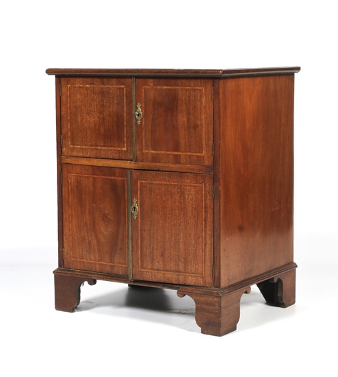 An Edwardian mahogany inlaid bedside cabinet. With two pairs of cupboard doors, inlaid with boxwood stringing, on bracket feet, L61cm x D46.5cm x H74cm