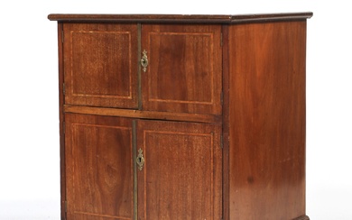 An Edwardian mahogany inlaid bedside cabinet. With two pairs of cupboard doors, inlaid with boxwood stringing, on bracket feet, L61cm x D46.5cm x H74cm