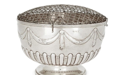 An Edwardian silver rose bowl, Sheffield, 1901, Hawksworth, Eyre & Co., the part-fluted sides to repousse garland band, raised on a stepped circular foot, 25.5cm dia., 16.8cm high, approx. weight 30.3oz
