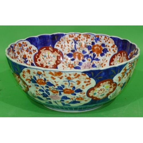 An Imari Round Scallop Shaped Bowl on white, blue and red gr...