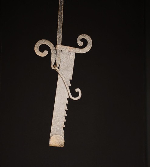 An Unusual Early 18th Century French Wrought Iron Trammel Hook with scroll terminals.