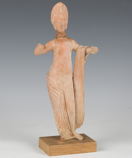 An ancient Greek Hellenistic style terracotta figure of Aphrodite, modelled semi-clad with both arms