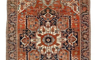 An antique Heriz carpet, North West Persia. A fine and highly decorative geometrical medallion design. C. 1900. 398×298 cm.