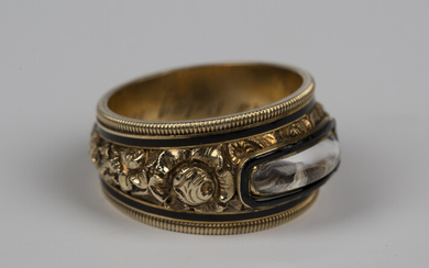 An early 19th century gold and black enamel mourning ring, glazed with a woven hair locket compartme