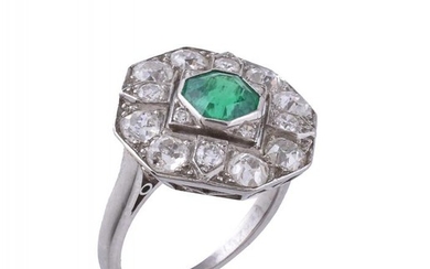 An emerald and diamond panel ring