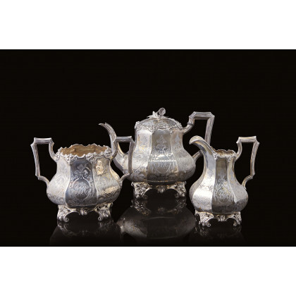 An engraved silver tea set comprising a teapot, a milk jug and sugar bowl. London, 1854. Silversmith William Ker Reid...