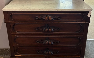 Antique American Victorian walnut marble top chest having four long drawers each with oak leaf and acorn carved pulls. 37 x 44 x 21 inches.