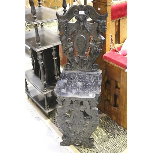 Antique Italian carved ebonized hall chair, with winged figu...