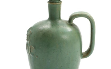 SOLD. Arne Bang: Stoneware pitcher modelled with inscription "C.L.O.C" in relief. Decorated with green glaze. H. 16 cm. – Bruun Rasmussen Auctioneers of Fine Art
