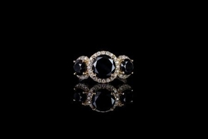 Black and white diamond trilogy halo ring, 3 round brilliant cut black diamonds estimated 3.60ct, surrounded by 40 round...