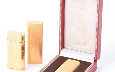 CARTIER, THREE GOLD PLATED GAS LIGHTERS