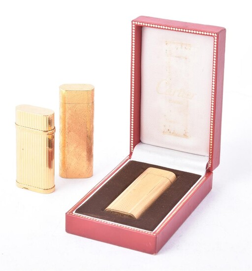 CARTIER, THREE GOLD PLATED GAS LIGHTERS