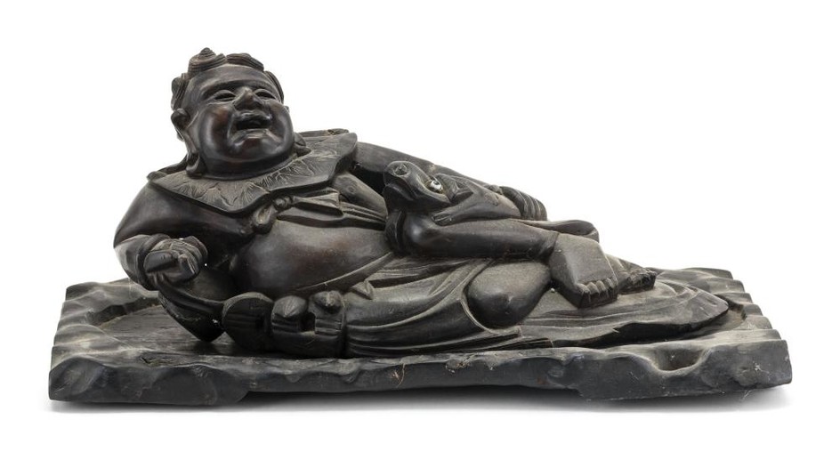 CHINESE CARVED WOOD FIGURE OF LIU HAI In reclining position and accompanied by a three-legged frog. On a carved wood stand. Total le...