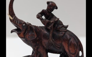 Finely Carved Chinese Hardwood Sculpture Of A Man Riding An Elephant