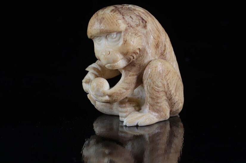 Japan Ivory okimono carved with a monkey with a fruit...